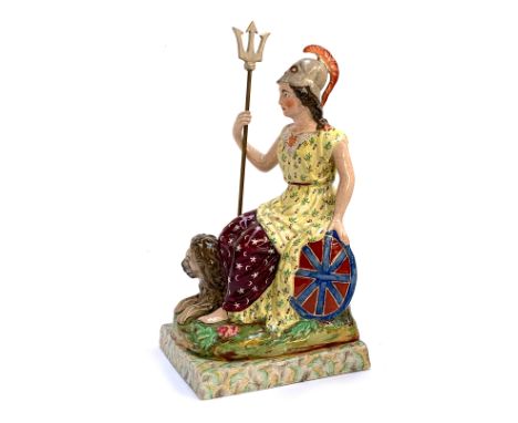 A 19th century Staffordshire pearlware figure of Britannia, seated holding a trident and shield with recumbent lion, 39.5cmH