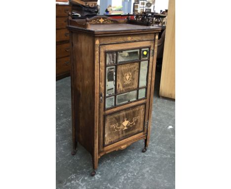 A late Victorian rosewood cabinet, with marquetry and bevelled mirrored door opening to shelves, on ceramic casters, 61x38x10