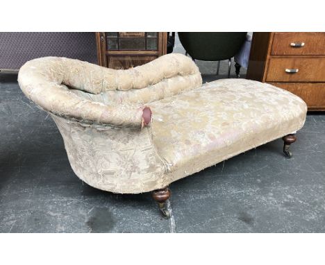 A Victorian button-upholstered chaise longue on turned mahogany legs, with brass caps and casters, 188cmL 