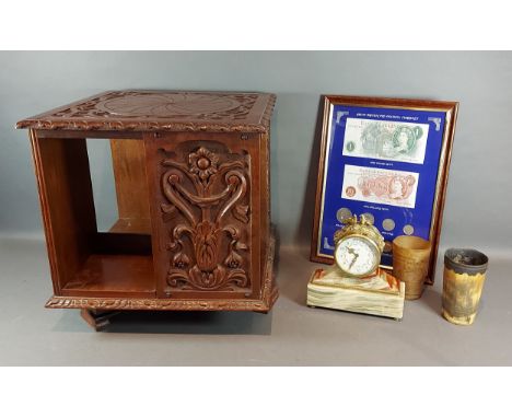 An carved oak table top revolving bookcase, 34cms tall together with a mantle clock, two horn cups and a framed Great British