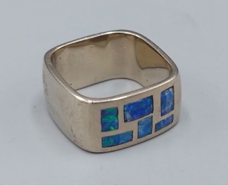 A 14ct gold Opal set band ring of square form, 11.4gms, ring size K