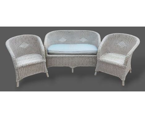 A Lloyd Loom style three piece suite comprising settee and a pair of matching chairs 