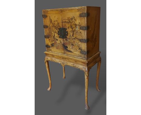 A Chinese lacquered chinoiserie decorated cabinet on stand, the top with two doors enclosing a shelf raised upon a shaped bas