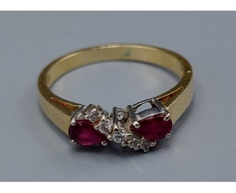 An 18ct gold Ruby and Diamond ring, set with a line of Diamond apposed by two Rubies, ring size M, 3.1gms