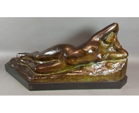 Eugene Canneel, a patinated bronze model of a female nude with marble base, signed, 55cms long, 25cms tall