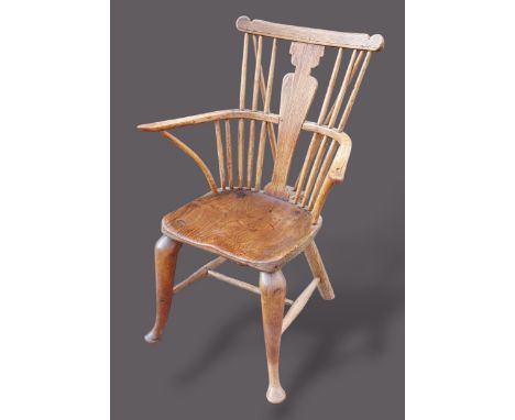 An early 19th Century elm Windsor armchair with a vase and stick back above a panel seat raised upon cabriole legs with pad f