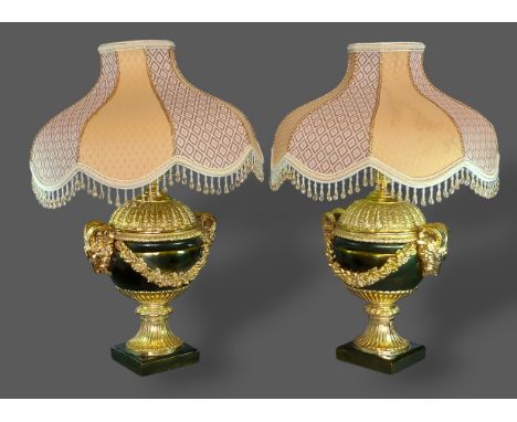 A pair of French style simulated bronze lamps with Rams head surmounts, 47cms tall excluding shades