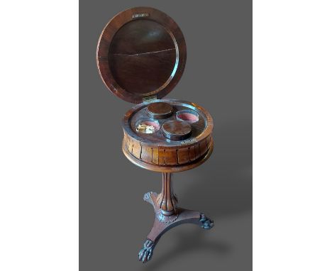 A William IV Rosewood Teapoy, the circular hinged top enclosing a fitted interior above a reeded column and platform base wit