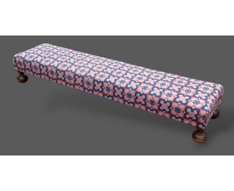 A long fender stool, the Kelim upholstered top above bun feet, 153cms long
