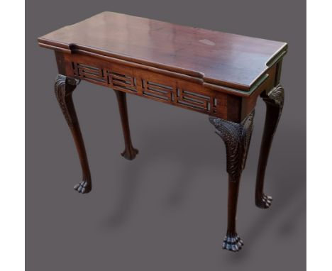 A 19th Century mahogany card table, the hinged top enclosing a beize lined interior above a pierced frieze raised upon cabrio