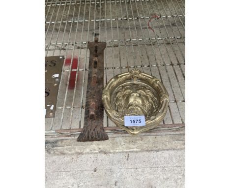 A LARGE BRASS LION HEAD DOOR KNOCKER AND A CAST IRON COAT HOOK 