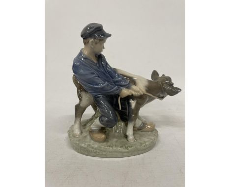 A ROYAL COPENHAGEN MODEL 772 OF A BOY FIGHTING WIH A CALF - DESIGN CHRISTIAN THOMSEN SIGNED WITH POLYCHROME UNDERGLAZE PAINTI