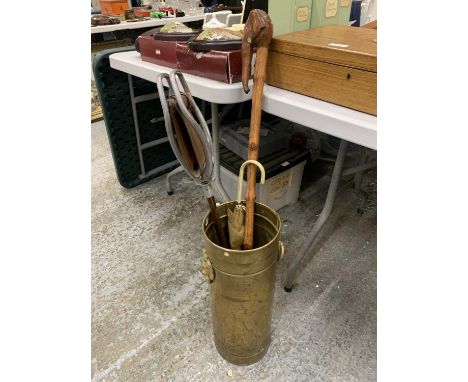 A VINTAGE BRASS STICK/UMBRELLA STAND WITH LION HANDLES, A SHOOTING STICK AND ELEPHANT HEADED WALKING STICK 