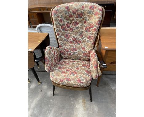 AN ERCOL FIRESIDE CHAIR WITH SPINDLE BACK AND ARM SUPPORT 