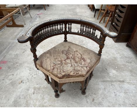 A MOORISH CARLO BUGATTI STYLE CORNER CHAIR INLAID WITH BONE AND MOTHER OF PEARL HAVING PROFUSE SPINDLE DECORATION 