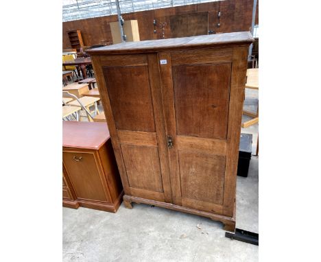 A 19TH CENTURY OAK TWO DOOR CUPBOARD ON BRACKET FEET, 39" WIDE 