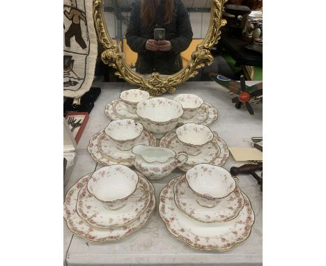 A VINTAGE CHINA PART TEASET WITH FLUTED EDGES AND A FLORAL PATTERN TO INCLUDE A SUGAR BOWL, CREAM JUGS, CUPS, SAUCERS AND SID