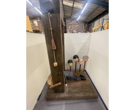 A MODEL OF A GUILLOTINE WITH FOUR VARIOUS HEADS 