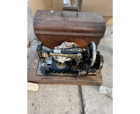 A VINTAGE REGIA SEWING MACHINE WITH WOODEN CARRY CASE 