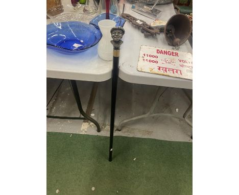 A VINTAGE WALKING STICK WITH A MAN'S HEAD WEARING  A TAM O' SHANTER FINIAL 