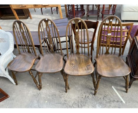 A SET OF FOUR ERCOL STYLE ELM AND BEECH HOOPED RAIL BACK DINING CHAIRS 