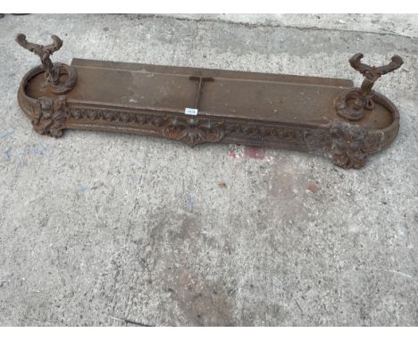 A VINTAGE HEAVILY DECORATED CAST IRON FIRE FENDER 