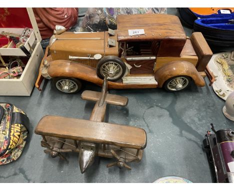 A LARGE WOODEN MODEL OF A CAR PLUS A SMALLER MODEL OF A BI-PLANE 