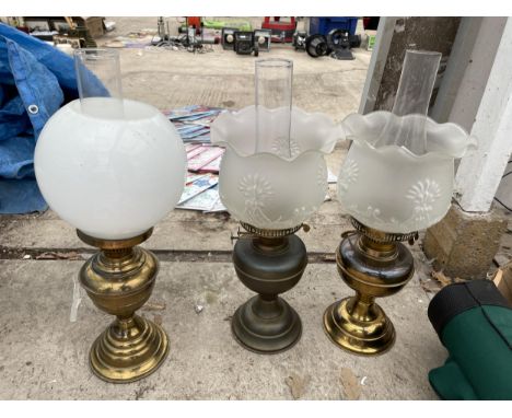 THREE VINTAGE BRASS OIL LAMPS WITH GLASS SHADES AND FUNNELS 