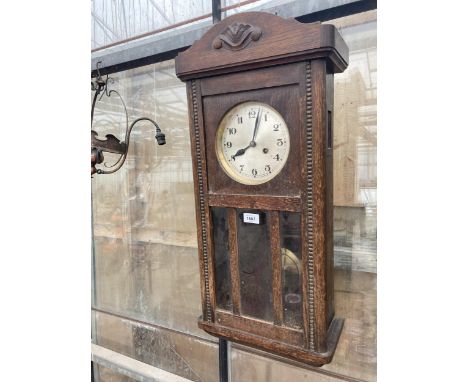 A VINTAGE OAK CASED CHIMING WALL CLOCK 