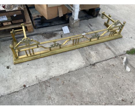 A DECORATIVE VINTAGE BRASS FIRE FENDER 