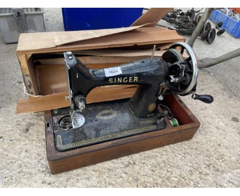 A VINTAGE SINGER SEWING MACHINE WITH A CARRY CASE 