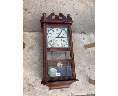 A WOODEN CASED 31 DAY CHIMING WALL CLOCK 