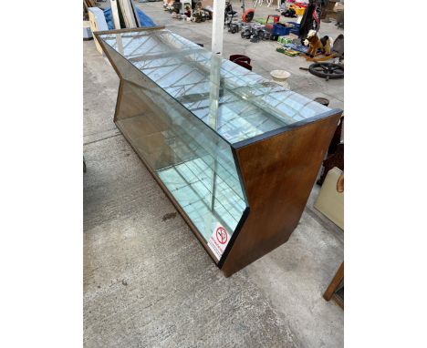A VINTAGE WOODEN AND GLASS SHOP DISPLAY UNIT WITH INVERTED FRONT 