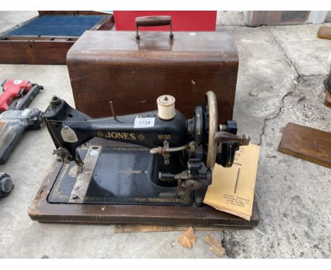 A VINTAGE JONES SEWING MACHINE WITH WOODEN CARRY CASE 