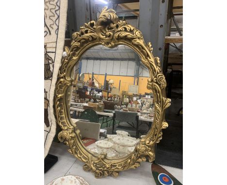 A VINTAGE STYLE GILT FRAMED OVAL MIRROR, 47CM X 64CM 