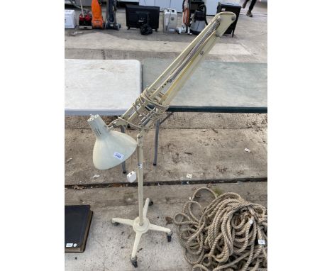 A VINTAGE ANGLE POISE LAMP ON FOUR WHEELED STAND 