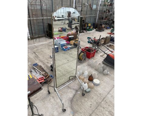 A VINTAGE METAL CHEVAL MIRROR ON FOUR WHEELED BASE 