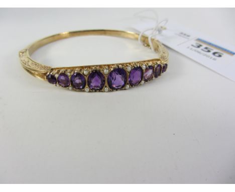 9ct gold hinged scrolled bangle set with amethyst and seed pearls hallmarked Condition Report Click here for further images, 