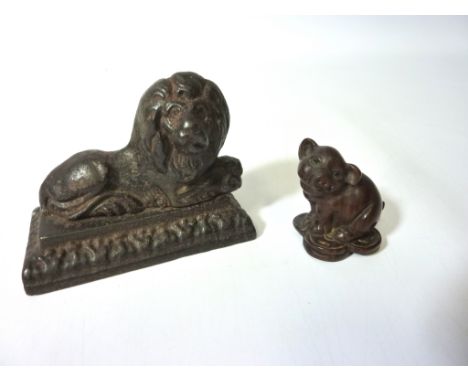 Japanese carved wood netsuke in the form of a pig, signed H5cm and a cast metal recumbent lion (2)  Condition Report Click he