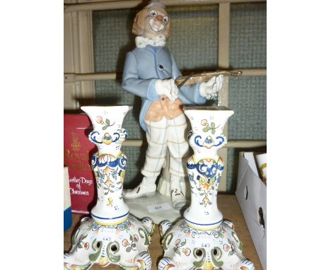 Pair of modern floral decorated Faience candlesticks and a porcelain figure of a clown playing a violin