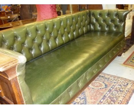 Large 20th Century green leather upholstered Chesterfield type three seat sofa with button back and oak panelled sides and ba