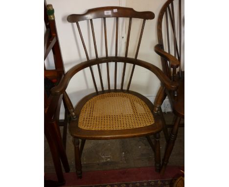 Early 20th Century stick back elbow chair with a cane seat together with a 20th Century wheel back elbow chair