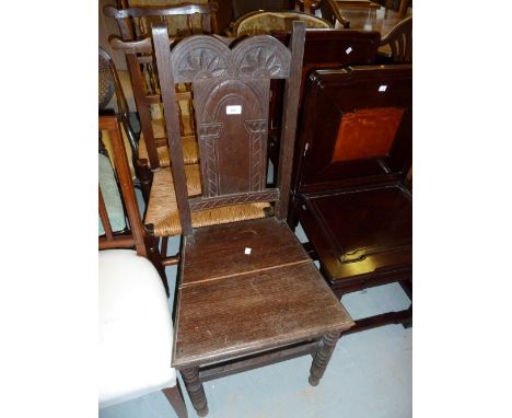 Oak hall chair with carved back rest raised on ring turned front supports together with an oak framed woolwork insert firescr