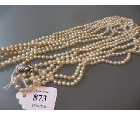Long triple row uniform cultured pearl necklace with a silver clasp