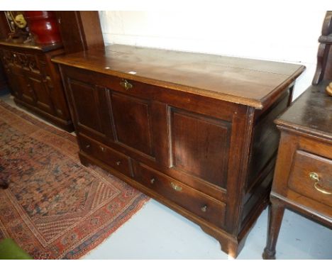 18th Century oak mule chest having moulded hinged cover above a three panelled front over two drawers with brass knob handles