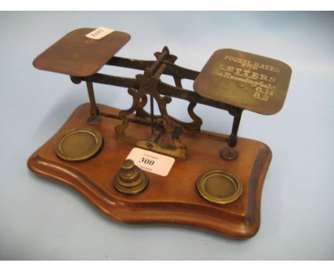 Pair of 19th Century brass postal scales on a walnut base