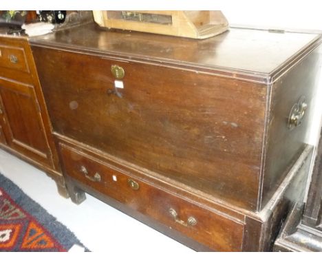 George II mahogany trunk on stand with a moulded hinged top, the base with a single long drawer and brass handles raised on s