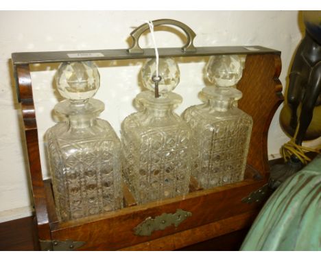 Victorian oak and metal mounted three decanter tantalus