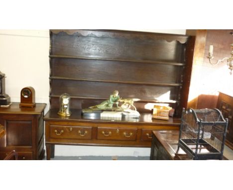 18th Century oak dresser with boarded shelf back above three drawers with brass swan neck handles, raised on cabriole front s