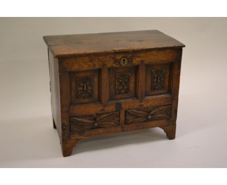 18th Century oak coffer bach, the hinged lid above three fielded panels and two drawers with plank back and sides and bracket